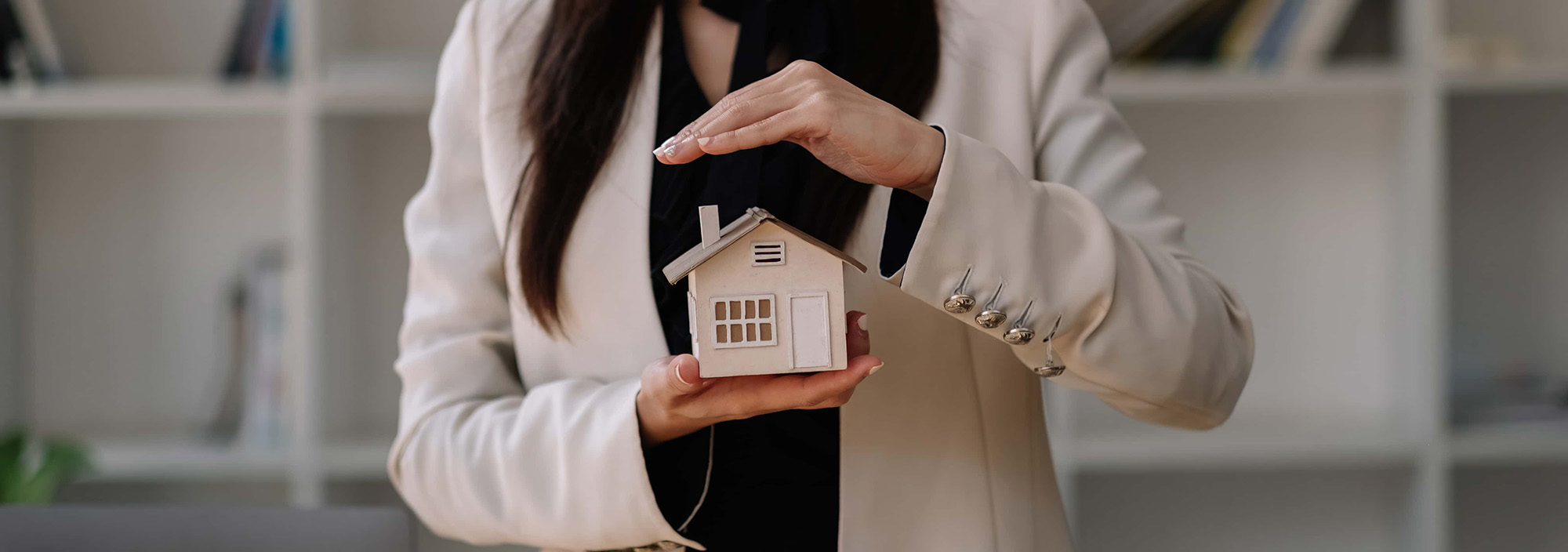 House covered of woman hands insurance real estate concept