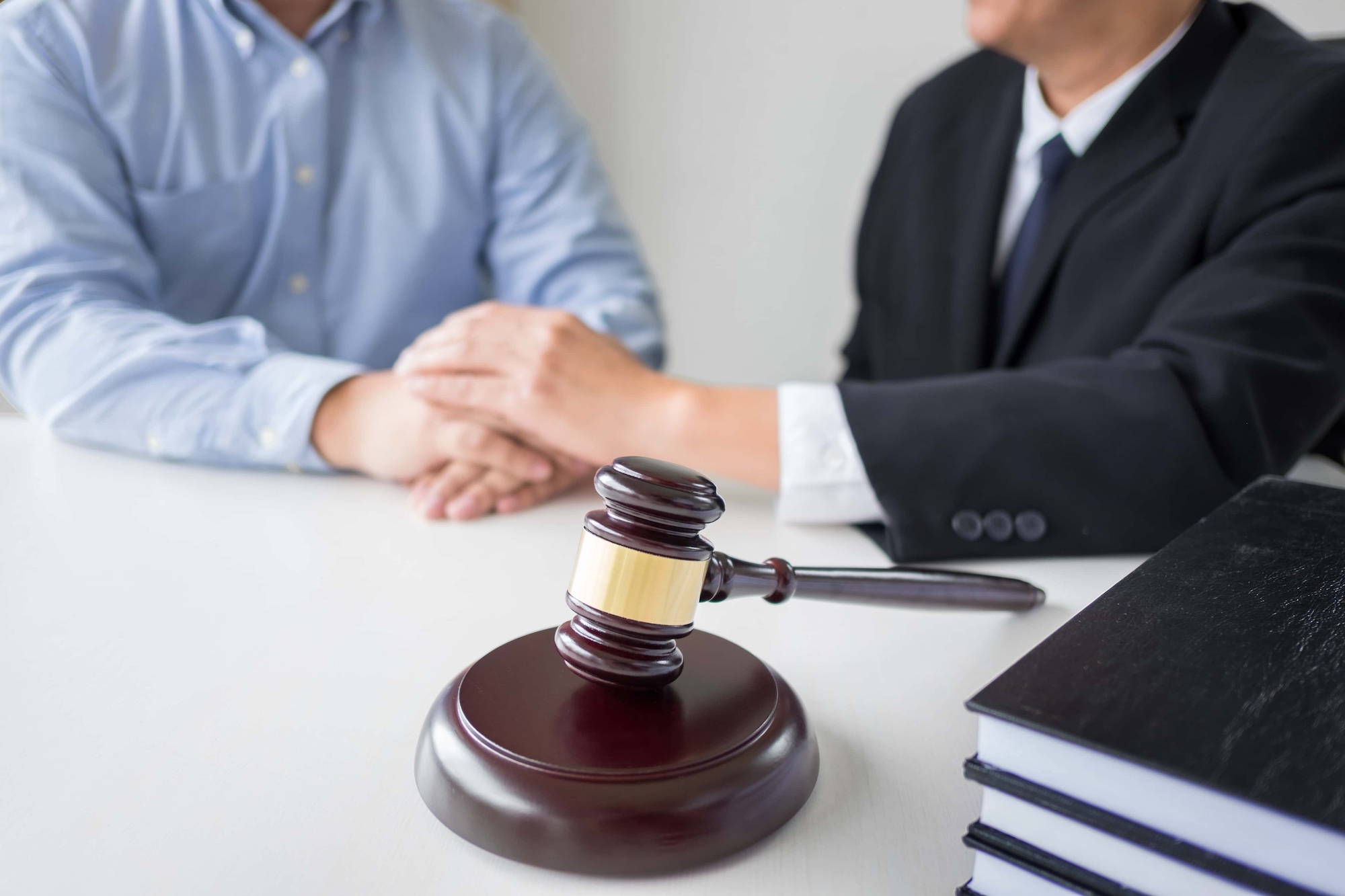 Judge gavel with lawyers advice legal at law firm in background. Concepts of law services