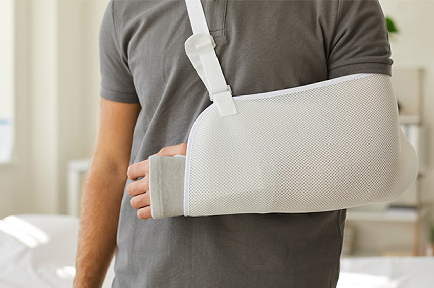 Man wear sling bandage on broken hand
