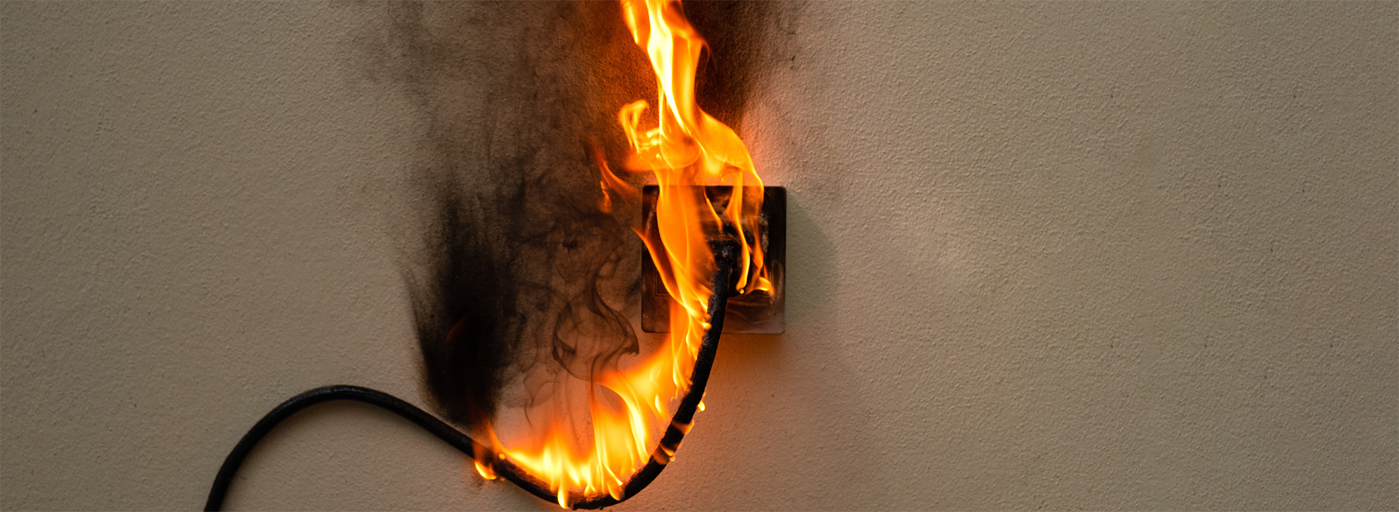 On fire electric wire plug Receptacle on the concrete wall