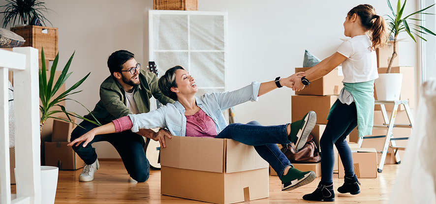 Playful parents and daughter having fun while moving into new house 1