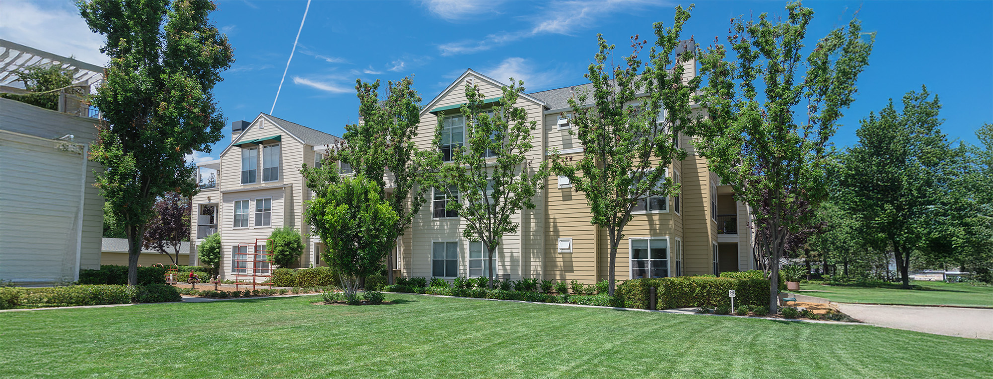 Playground and grassy backyard at apartment building complex in Palo Alto California USA