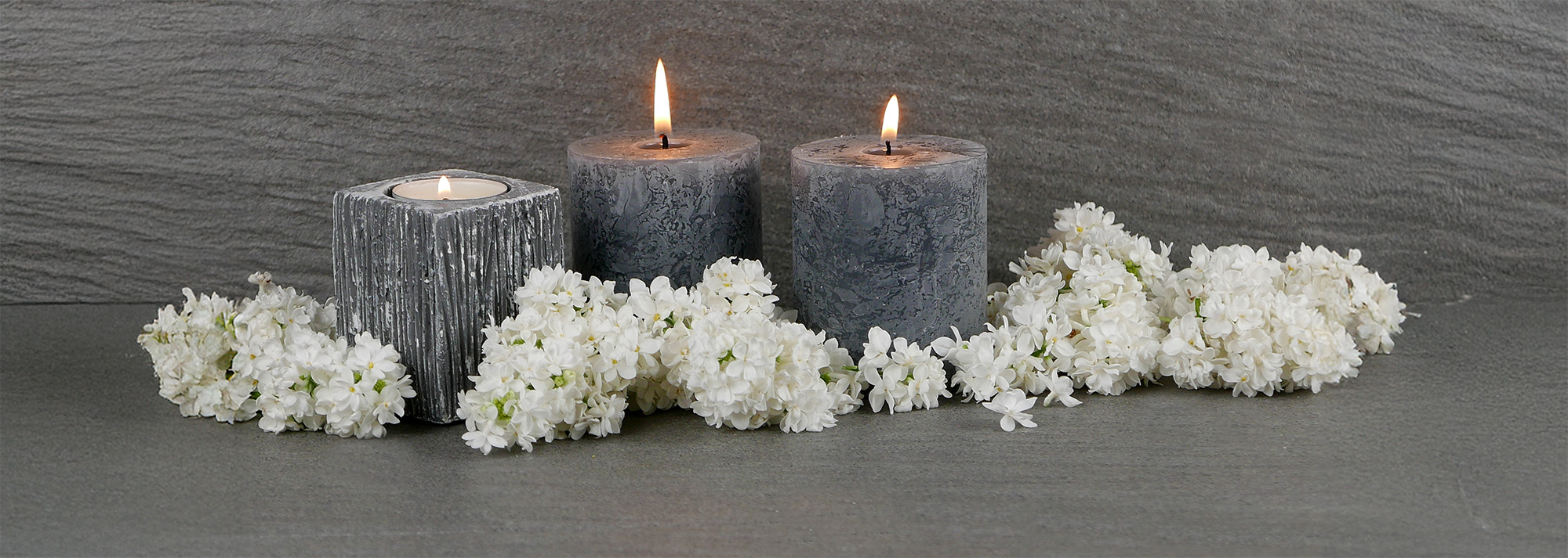flowers and candle arranged on marble