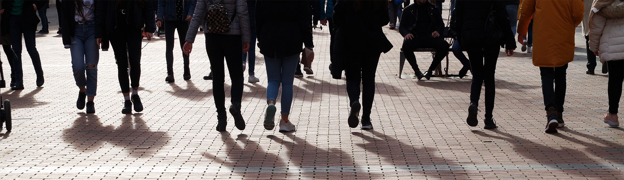 youth walking on the sidewalk photo of the bottom